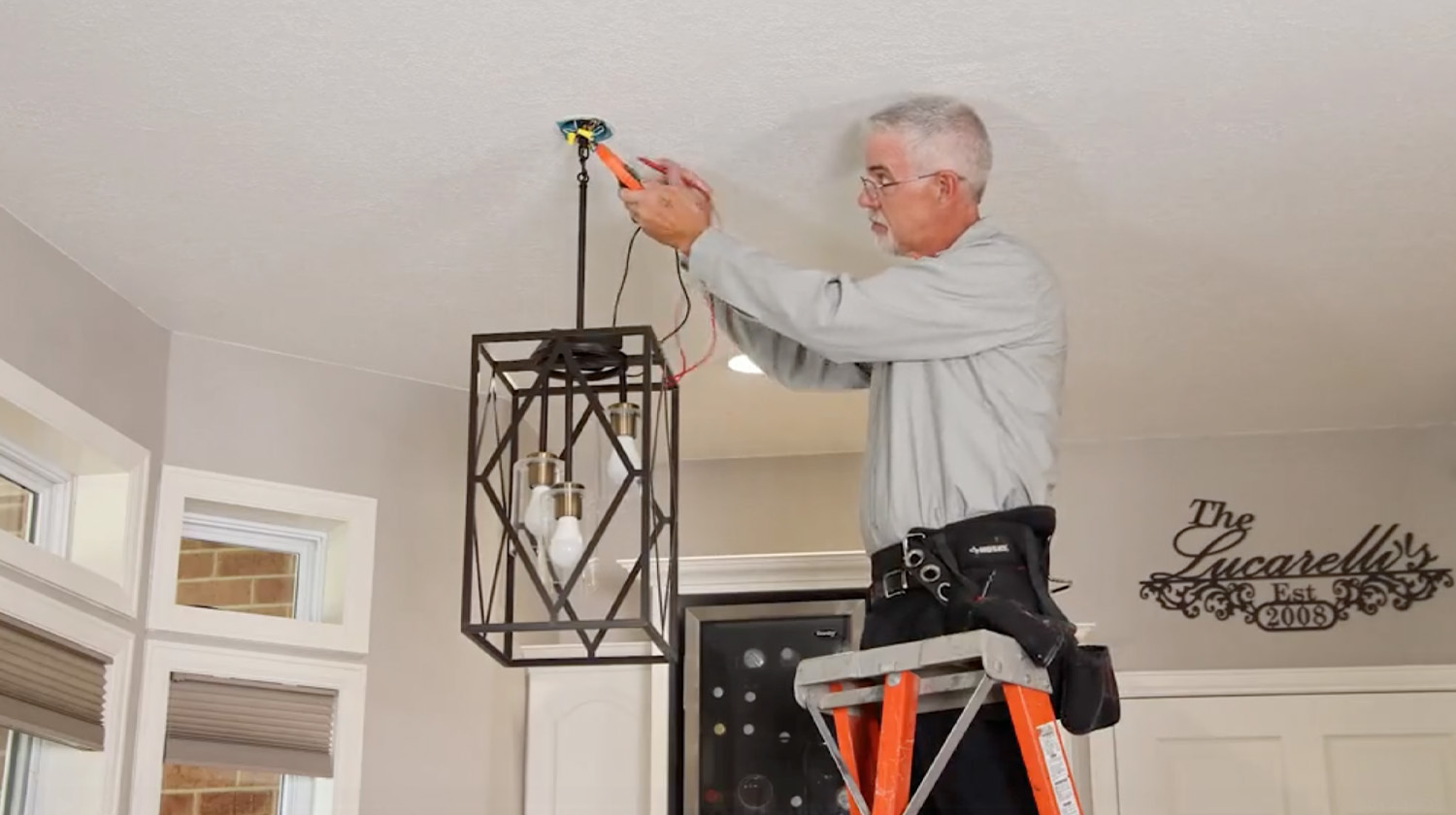 M&M electrician installing a light fixture