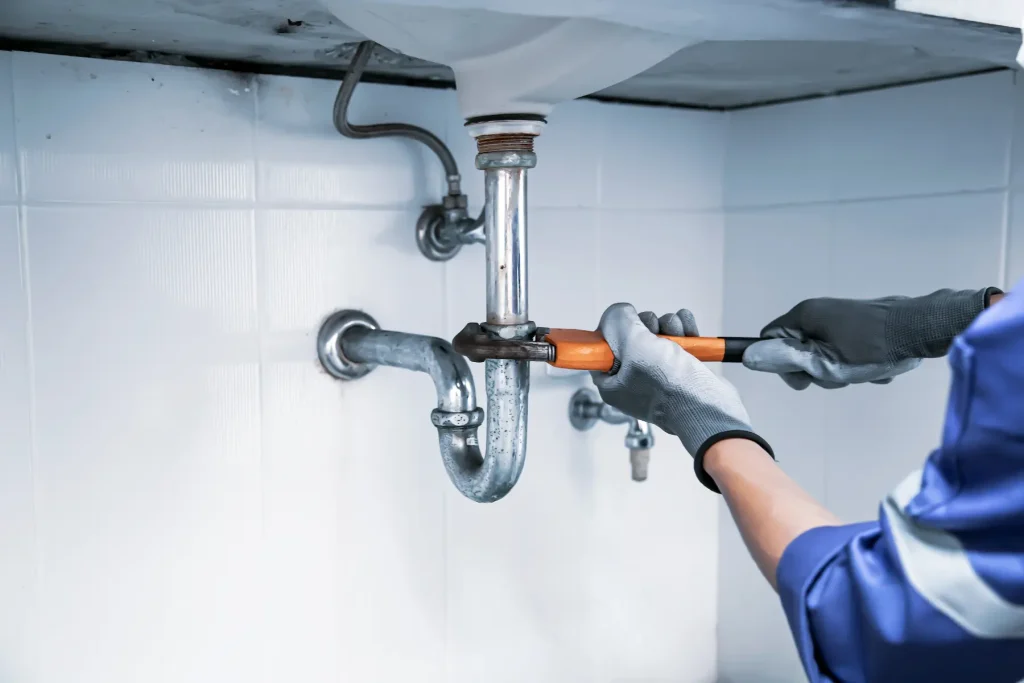 Plumber installing a kitchen faucet