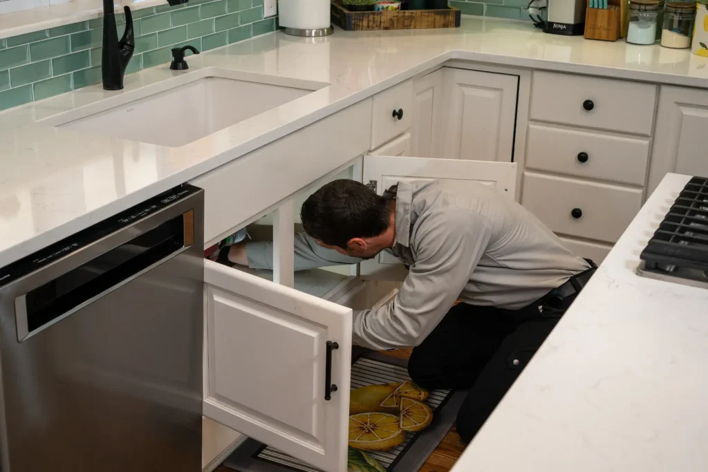M&M plumber inspecting a drain line