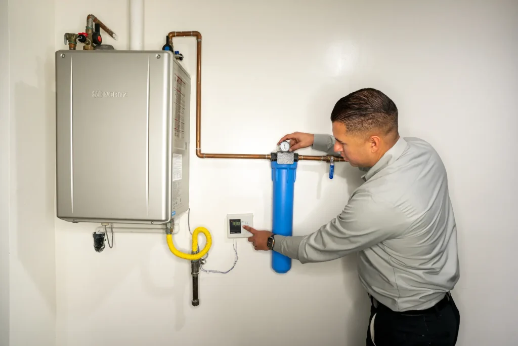 M&M plumber inspecting a water heater